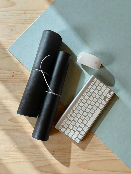 Genuine leather desk mat rolled up, showing the leather's soft, flexible quality