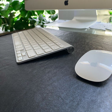 Genuine Leather Desk Mat in black on glass desk with keyboard and mouse 