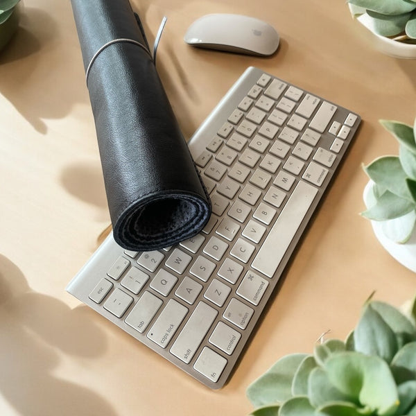 Genuine black leather Desk Mat on desk rolled up 
