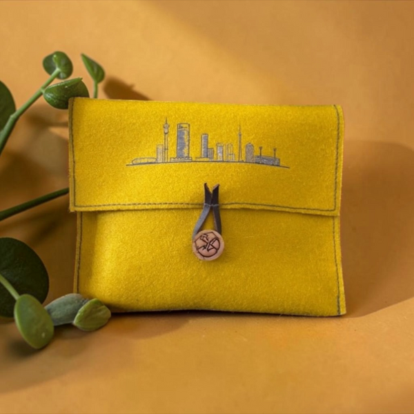 Yellow pure wool felt pouch with black  Joburg skyline  print, wooden button and leather loop closure